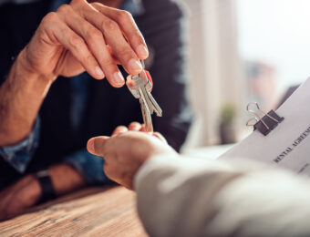 landlord handing over property keys to tenant