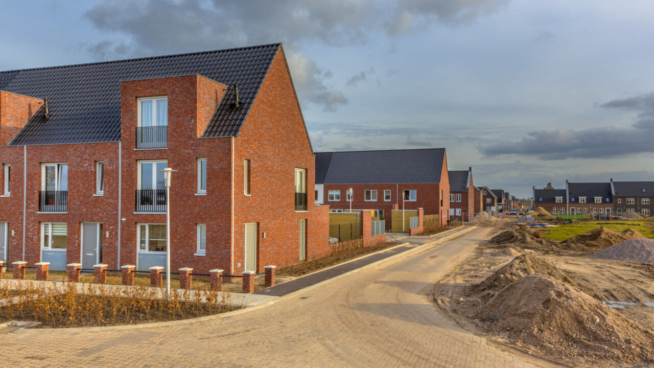 Newly built houses in modern street building site in suburb of city in the Netherlands